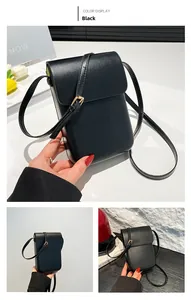 Detail shot of black minimalist phone crossbody bag with gold hardware and flap closure