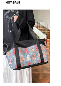 Detalle del bolso de viaje grande de nylon con estampado de conejo y cremallera roja