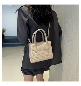 Rückansicht eines Models mit gesteppter cremefarbener Tasche aus Kunstleder und Trageriemen