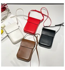 Flat lay of minimalist matte leather crossbody phone bags in four stylish colors