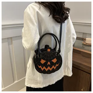 Detailed view of pumpkin-shaped crossbody bag with Jack-o'-lantern spiderweb stitching