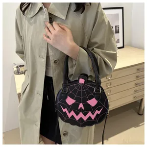 Detailed view of the Halloween pumpkin shoulder bag with pink spider web and funny face