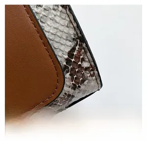 Close-up of brown faux leather stitched with tricolor snakeskin textured fabric