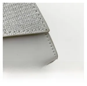 Detail shot of silver glitter fabric and white matte leather with clean stitching lines