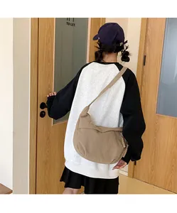 Detail of khaki corduroy texture on oversized crossbody bag with wide shoulder strap