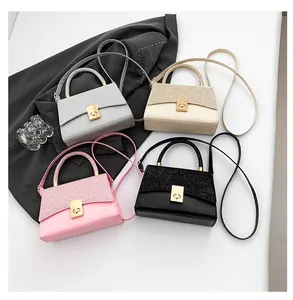 Flat lay of small crossbody bags in four colors with sequin patchwork and gold locks