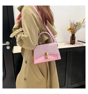 Chic pink color-block handbag detail with sequin texture and golden rotary lock mechanism