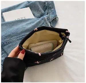Quilted corduroy pouch interior showing large storage capacity for phone and wallet
