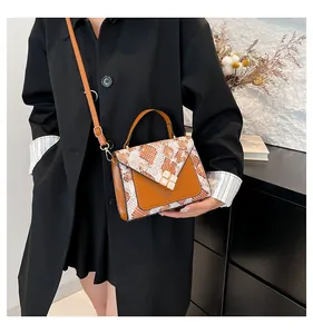 Close-up of caramel and snakeskin PU leather handbag with elegant square buckle detail