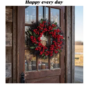Detail of a festive Christmas wreath with red berries and green leaves on wooden door