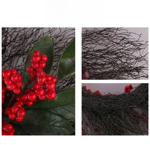 Detailed macro view of festive red berries, green leaves, and textured brown twigs