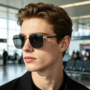 Male model wearing small square polarized metal sunglasses in a bright airport terminal