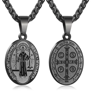 Macro detail of double-sided St. Benedict religious cross pendant in gunmetal black finish
