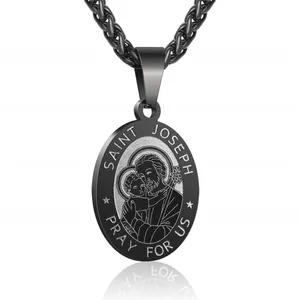Macro shot of matte black Saint Joseph religious pendant with detailed engraving