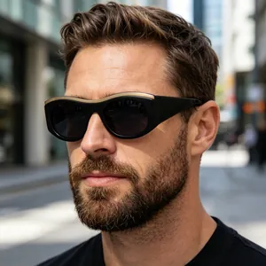Detail of black wide-frame cat-eye sunglasses with luxury gold metal inlay on the temple
