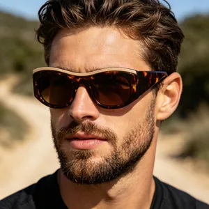 Detail shot of vintage tortoise shell sunglasses with wide frames and dark brown lenses