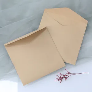Close-up of vintage brown kraft paper envelopes in two sizes with elegant dried flower decor