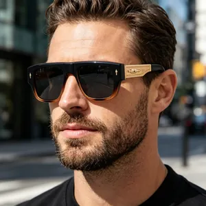 Close-up of man wearing stylish retro square frame sunglasses with gold temples