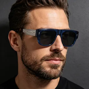Detailed view of luxury retro square sunglasses with engraved metal temples on a male model.