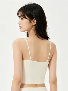Detail view of seamless beige camisole bra with thin adjustable straps and smooth fabric