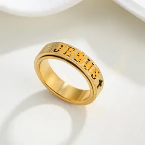 Detail shot of a 6mm gold-plated titanium steel spinner ring with frosted texture.