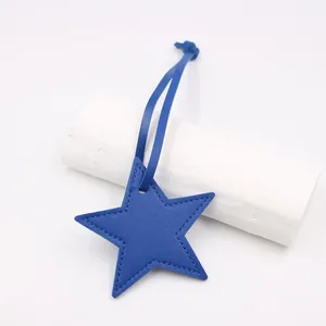 Detailed view of navy blue star-shaped PU leather pendant with lychee texture and fine stitching