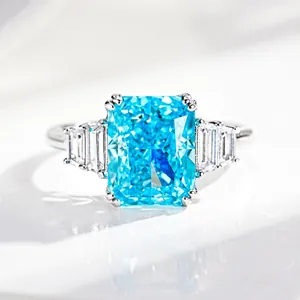 Macro detail of 4ct emerald-cut blue aquamarine ring with classic four-prong silver setting