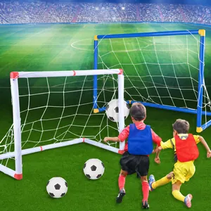 Detail of stable kids' football goal set with white nets and soccer balls on green turf