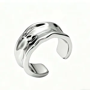 Macro shot of minimalist polished S925 silver ear cuff with irregular lava design detail