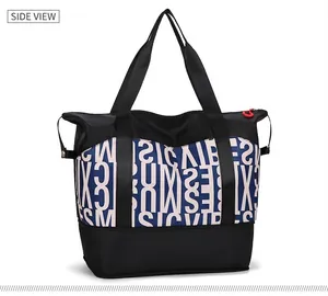 Macro detail of large capacity travel tote featuring letter print and durable handles