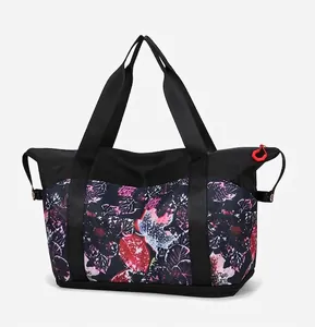 Detail view of large tote bag showing bottom zipper compartment and tropical leaf pattern