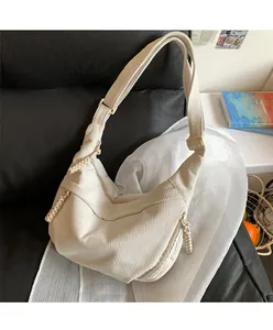 Detail of off-white corduroy hobo bag showing soft texture and adjustable strap buckle