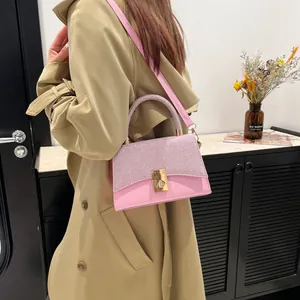 Pink crossbody square bag with shimmering rhinestones and gold twist lock closure