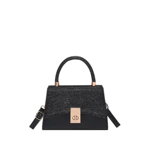 Elegant black glitter crossbody bag with gold rectangular lock and sleek handle