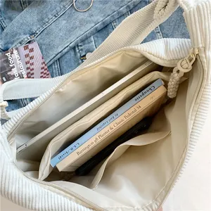 White corduroy crossbody crescent bag with large capacity interior and zipper closure