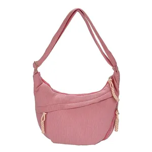 Pink corduroy crossbody crescent bag with large capacity and woven zipper detail