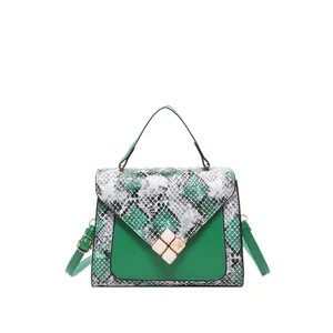 Minimalist green and snake print crossbody bag with a gold buckle and top handle