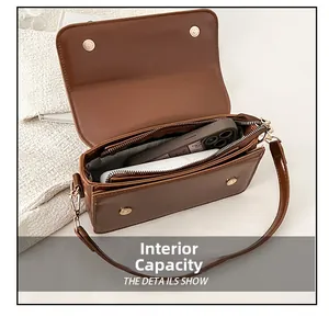 Detail view of the brown leather shoulder bag interior showing internal storage capacity