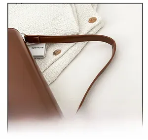 Detail view of the fine brown leather strap and stitching on the vintage baguette bag