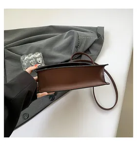 Detail shot of brown crocodile pattern bag bottom showing clean edge paint and fine stitching