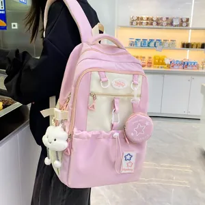 Detail of pink Korean style backpack with cute cloud plush pendant and small coin purse