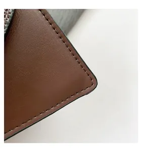 Close-up of brown faux leather bag showing precise stitching and edge oil finishing