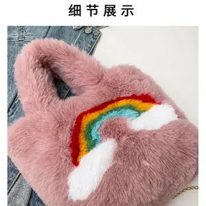 Detail view showing soft pink faux fur texture and a colorful stitched rainbow pattern