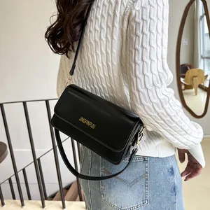 Classic black rectangular flap shoulder bag with gold lettering and slim shoulder strap