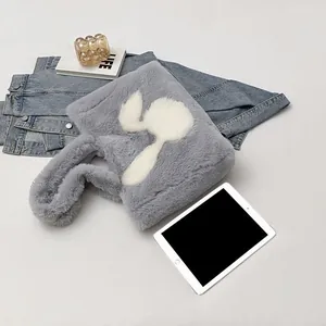 Detailed view of gray faux fur tote bag with plush rabbit motif and soft handles
