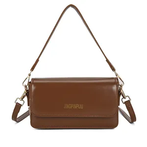 Brown rectangular crossbody flap bag with gold hardware and adjustable strap in minimalist style