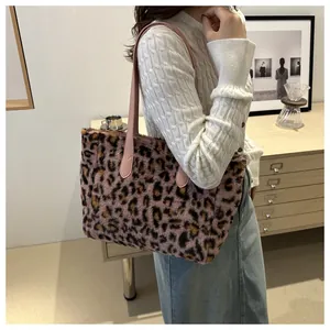 Detail of pink leopard print plush tote bag featuring soft faux fur and leather straps