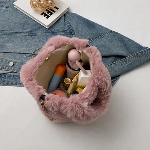 Pink plush bucket bag with golden chain showing interior storage for daily items