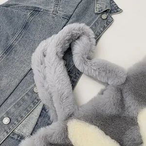 Detailed close-up of fluffy gray and white faux fur tote bag on blue denim jacket