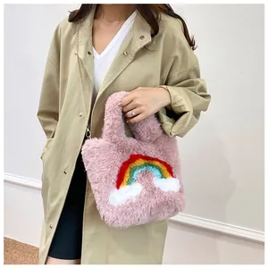 Detailed close-up of pink faux fur bag featuring colorful rainbow and cloud patterns